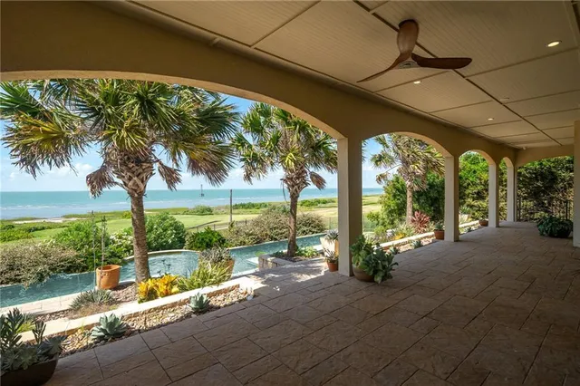 a view of a house with backyard and porch