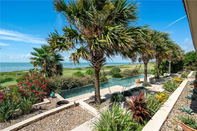 a view of a house with backyard porch and sitting area
