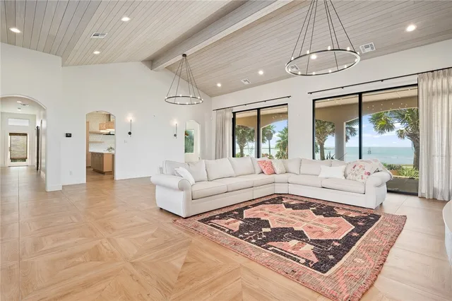 a living room with furniture and a chandelier