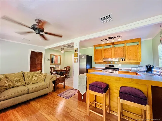 a living room with fireplace furniture and a large window