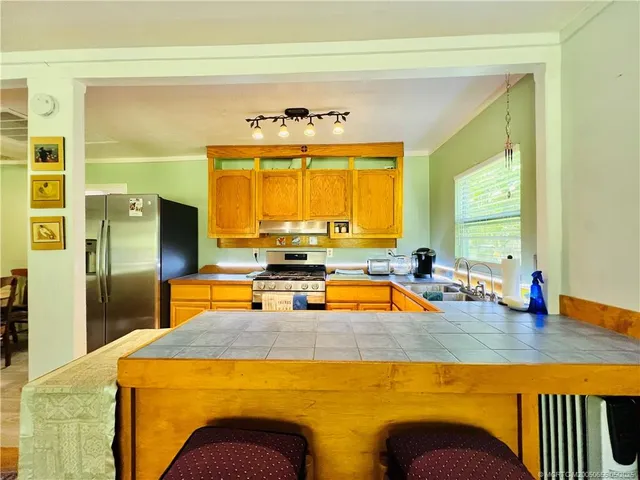 a view of a swimming pool with a table chairs in front of it