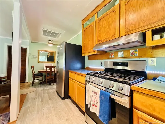 a kitchen with stainless steel appliances granite countertop a stove a refrigerator and a microwave
