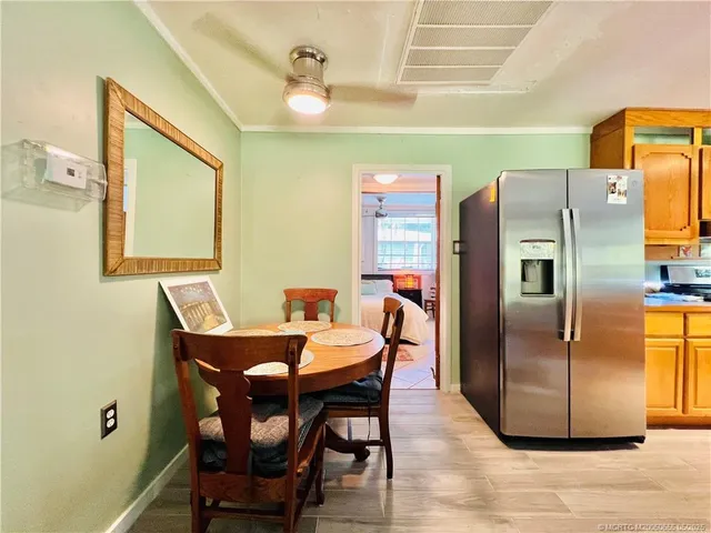 a view of a dining room with furniture and a chandelier