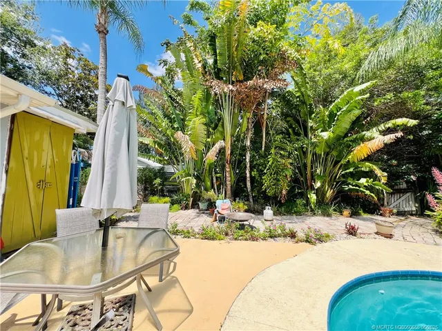 a swimming pool with outdoor seating and yard