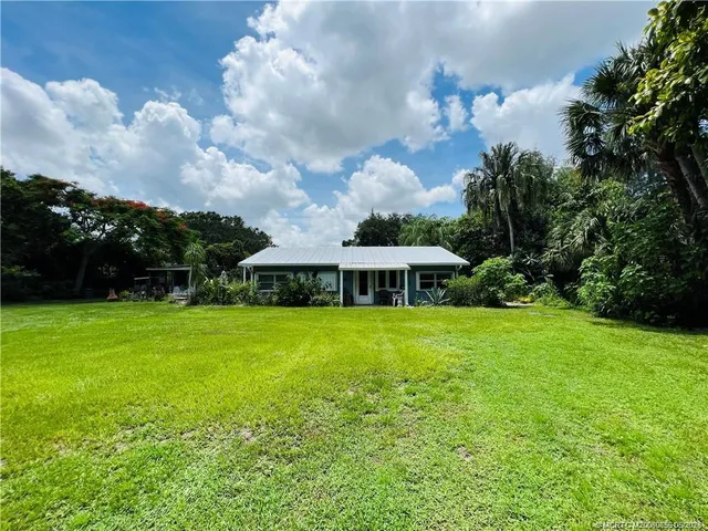 a view of a big yard in front of a house