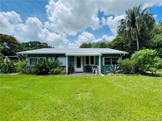 a view of house with outdoor space and swimming pool