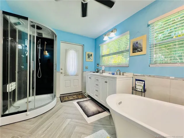 a bathroom with a tub sink and mirror