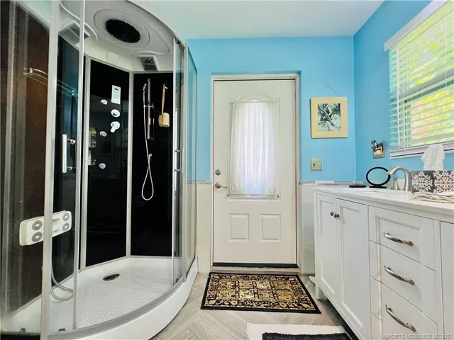 a bathroom with a sink a toilet and shower
