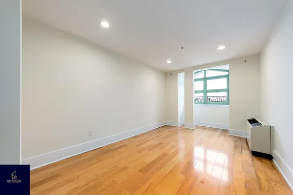 a view of an empty room and a window