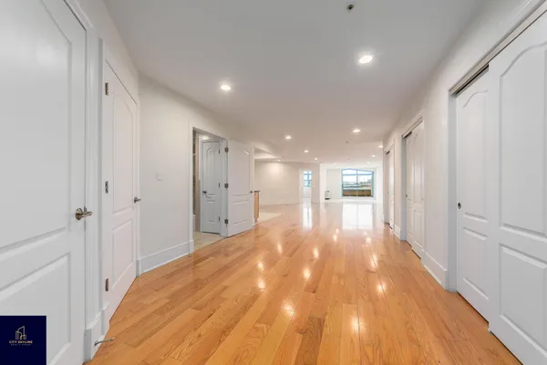 a view of a hallway with wooden floor
