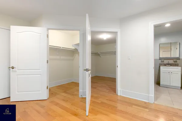 an empty room with cabinet and mirror