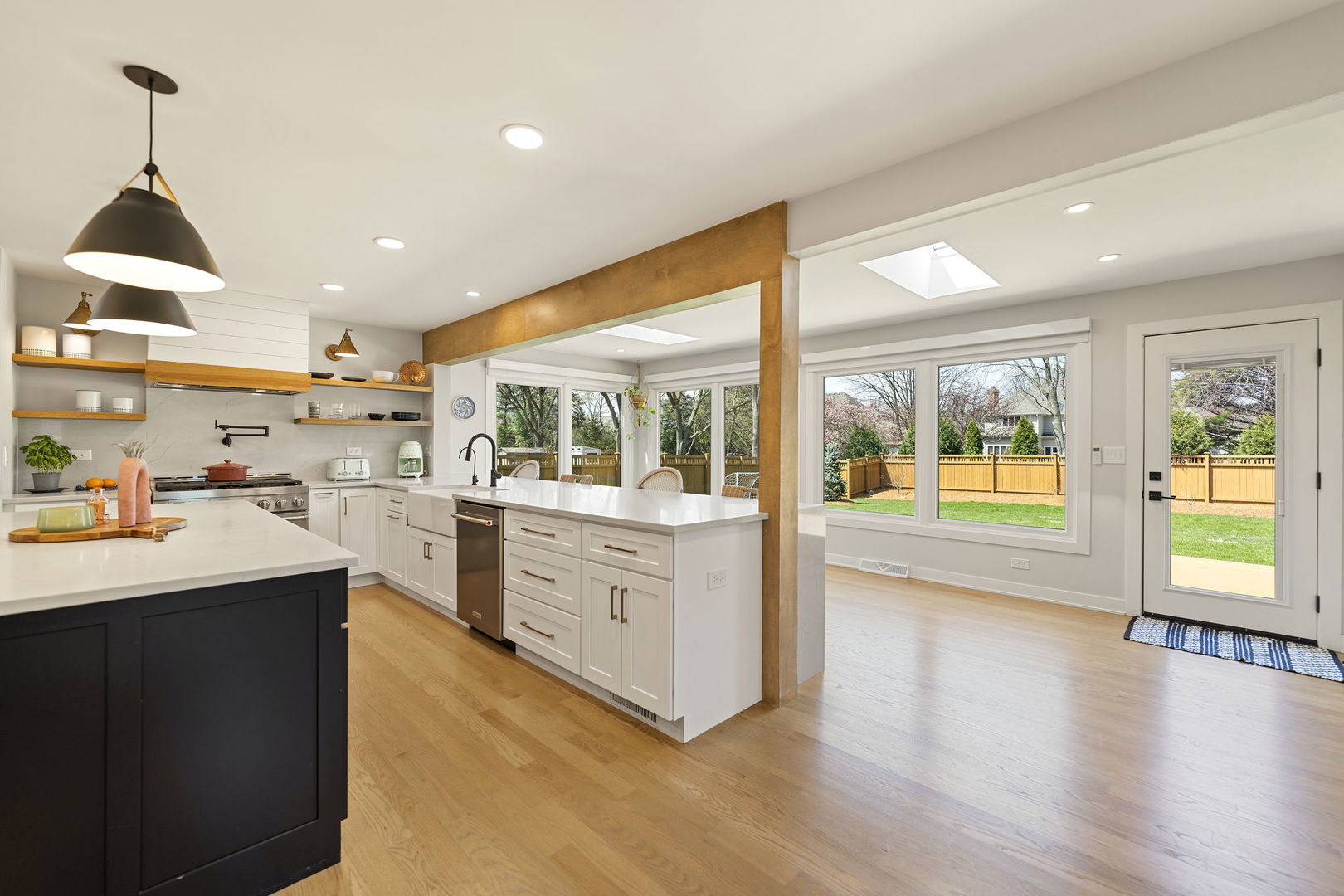 675 Cavalcade Circle Naperville, IL 60540 - Photo 11 of 58 a open kitchen with stainless steel appliances granite countertop a refrigerator a sink dishwasher a stove and a dining table with wooden floor