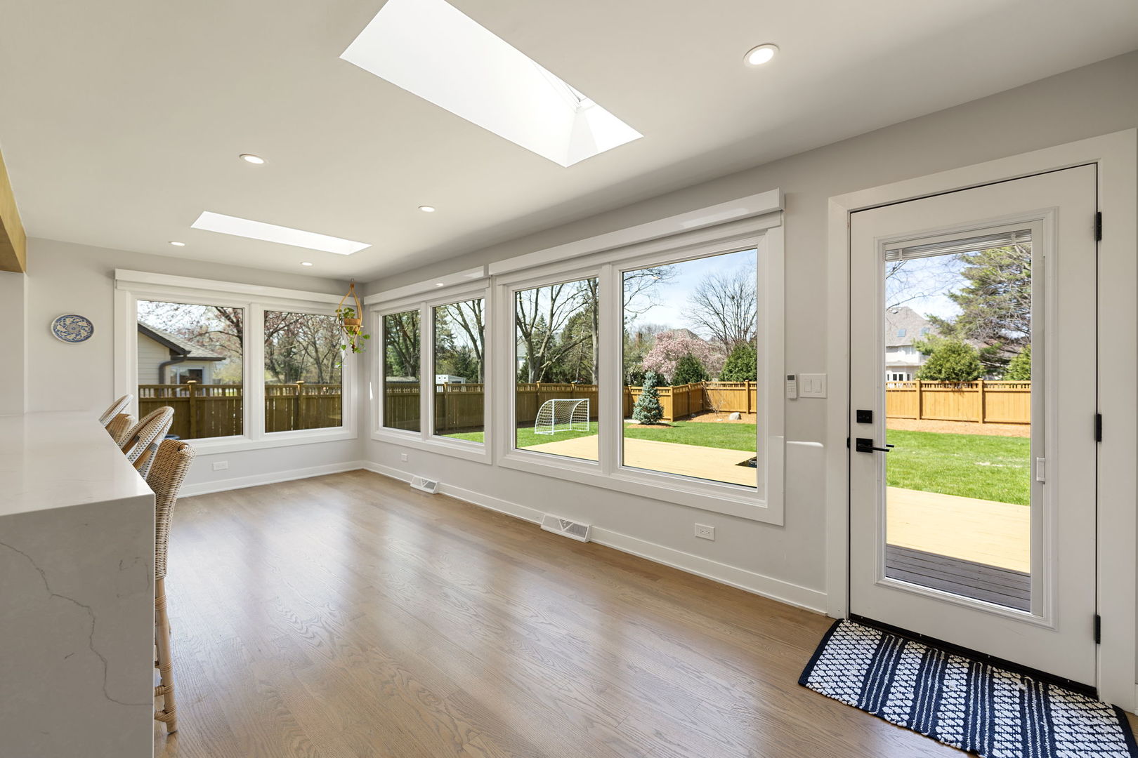 675 Cavalcade Circle Naperville, IL 60540 - Photo 12 of 58 a view of an empty room with wooden floor and a window