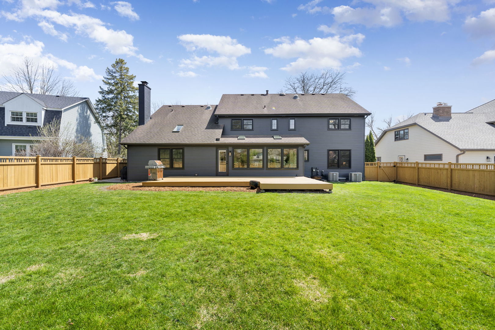675 Cavalcade Circle Naperville, IL 60540 - Photo 48 of 58 a front view of a house with a yard table and chairs