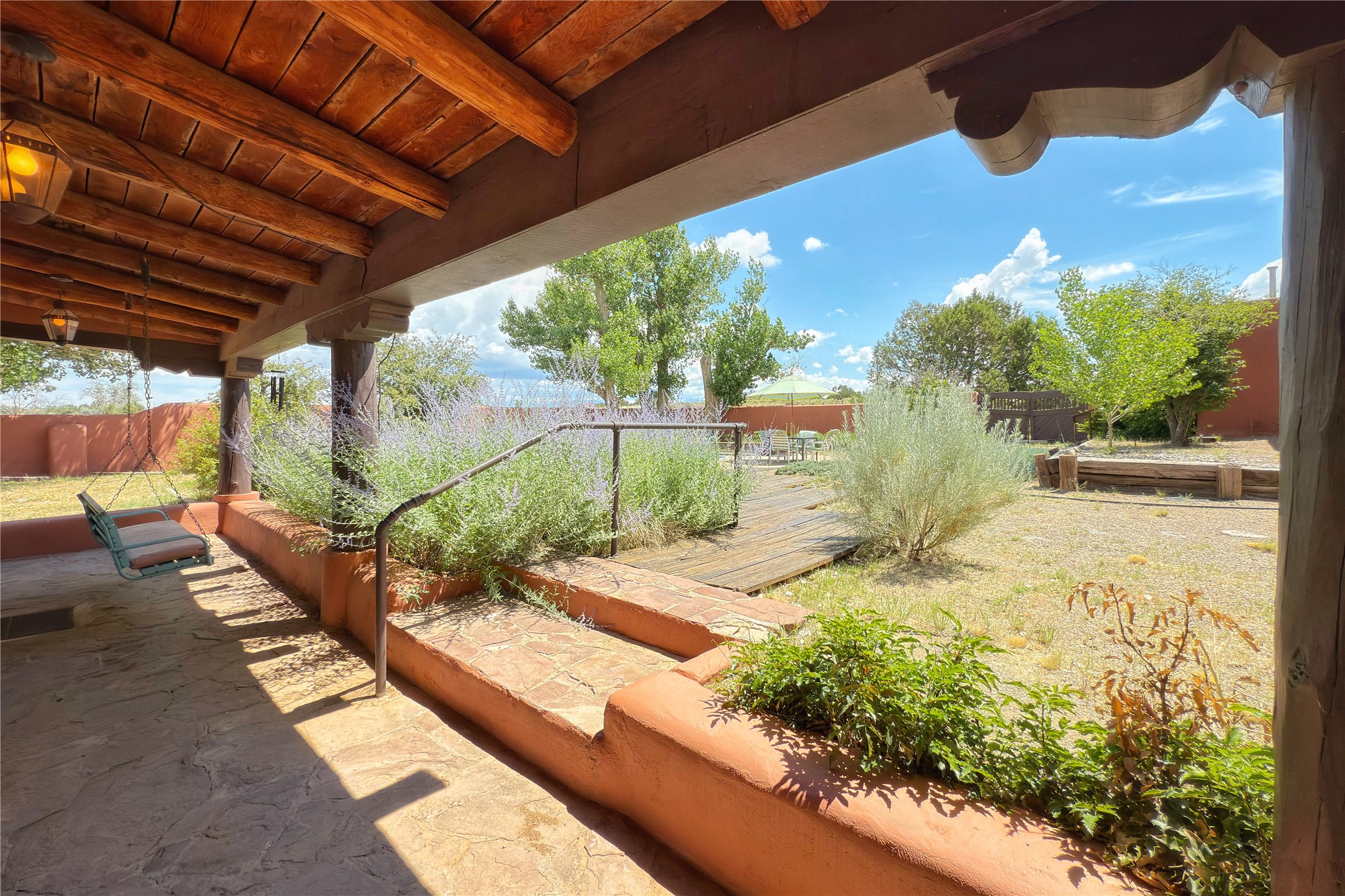 54 Rons Road Santa Fe, NM 87508 - Photo 57 of 99 Covered portal the complete length of house