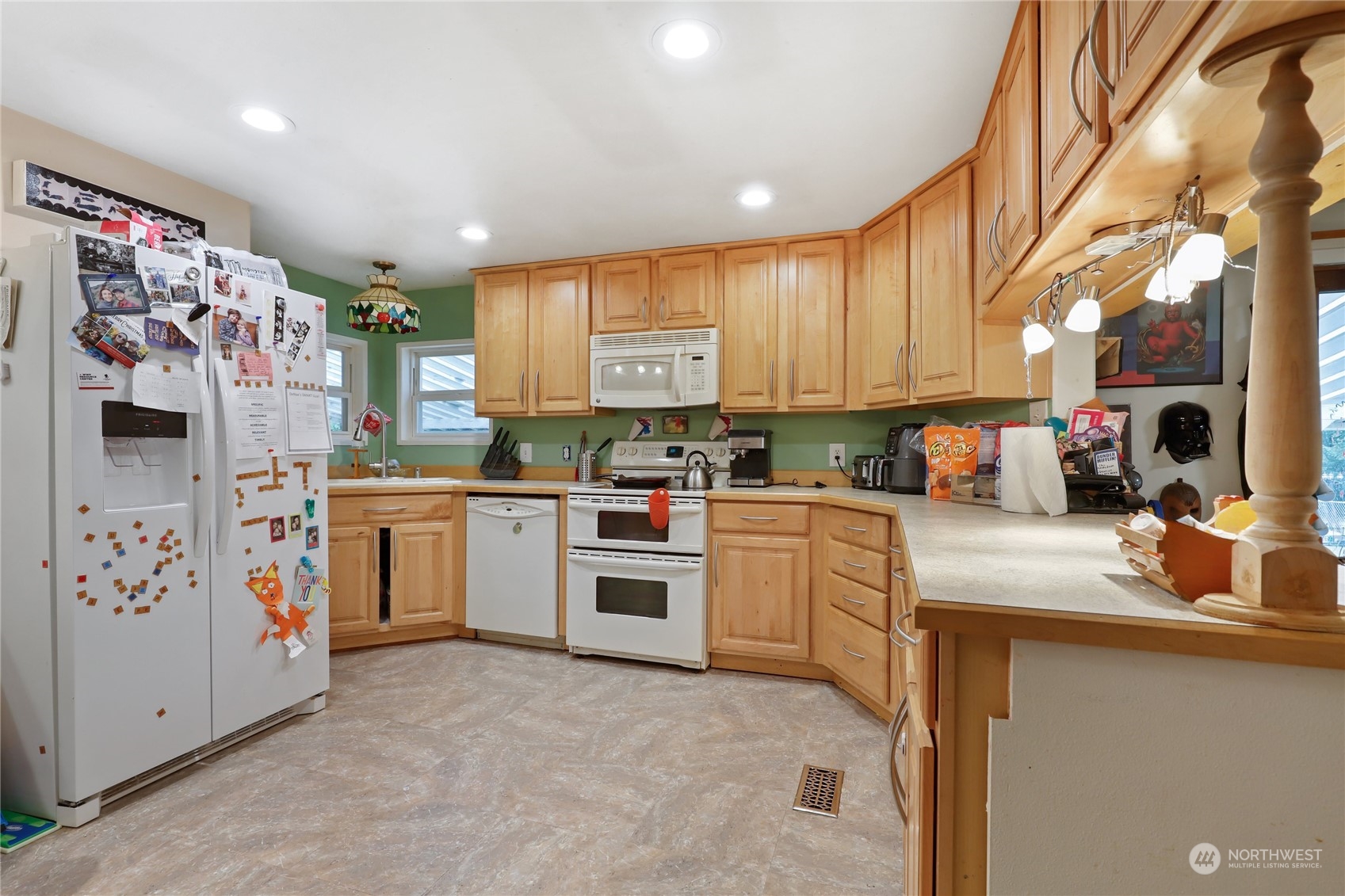 10909 Sidney Road Southwest Port Orchard, WA 98367 - Photo 11 of 34 a kitchen with white cabinets and white appliances