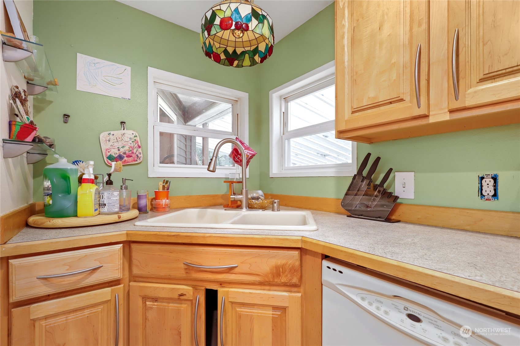 10909 Sidney Road Southwest Port Orchard, WA 98367 - Photo 12 of 34 a kitchen with a sink cabinets and a window