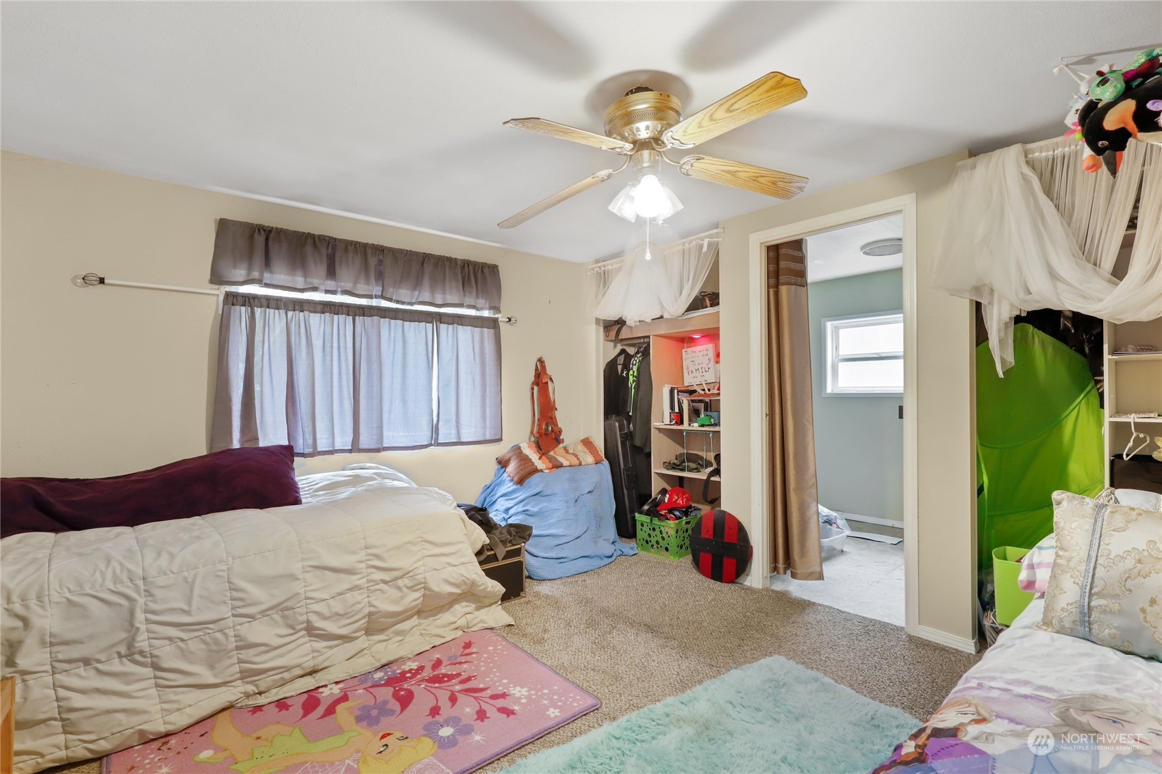 10909 Sidney Road Southwest Port Orchard, WA 98367 - Photo 14 of 34 a bed room with a bed and a ceiling fan