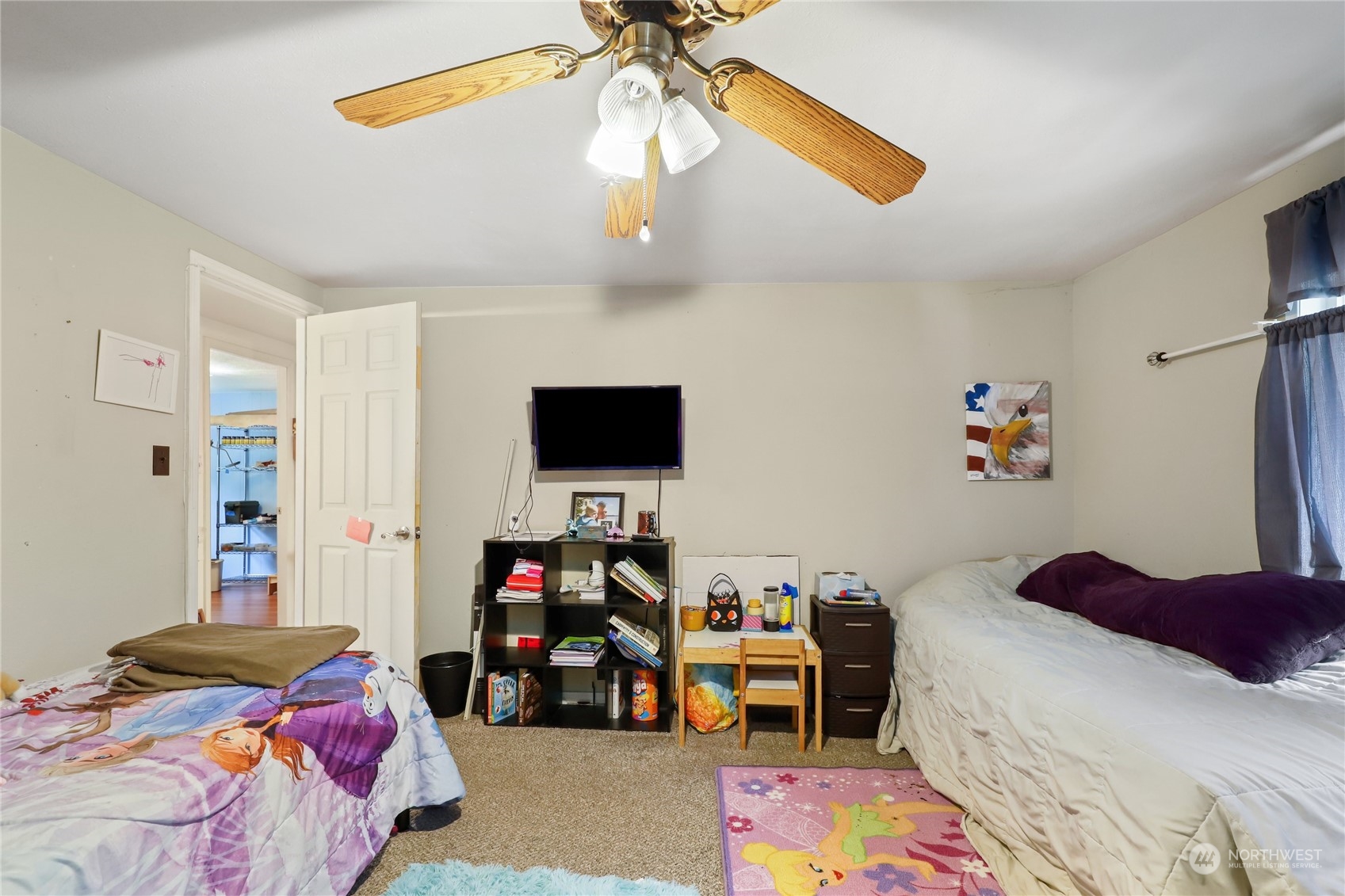 10909 Sidney Road Southwest Port Orchard, WA 98367 - Photo 16 of 34 a bedroom with a bed and a chandelier