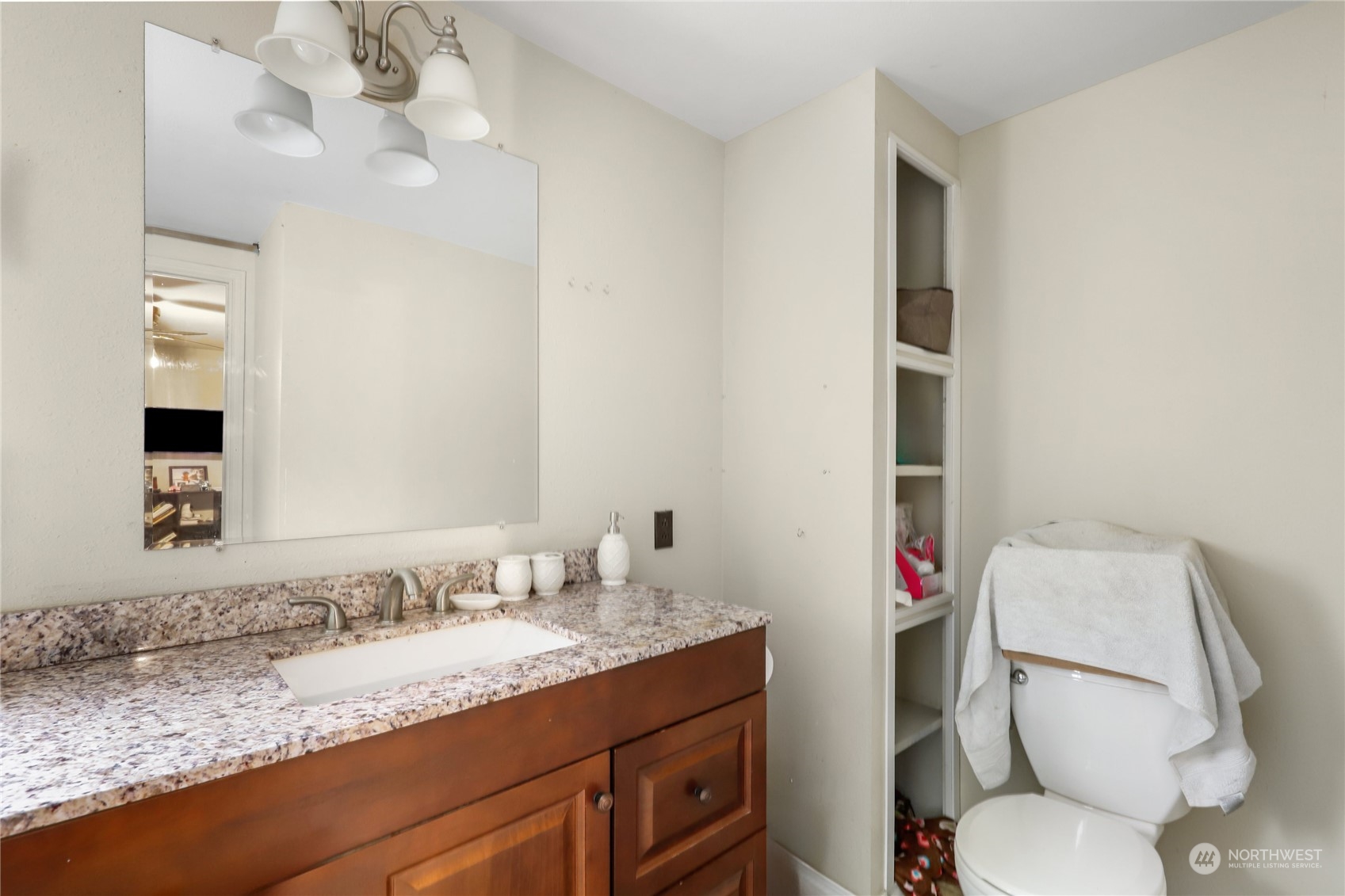 10909 Sidney Road Southwest Port Orchard, WA 98367 - Photo 18 of 34 a bathroom with a granite countertop toilet sink and mirror
