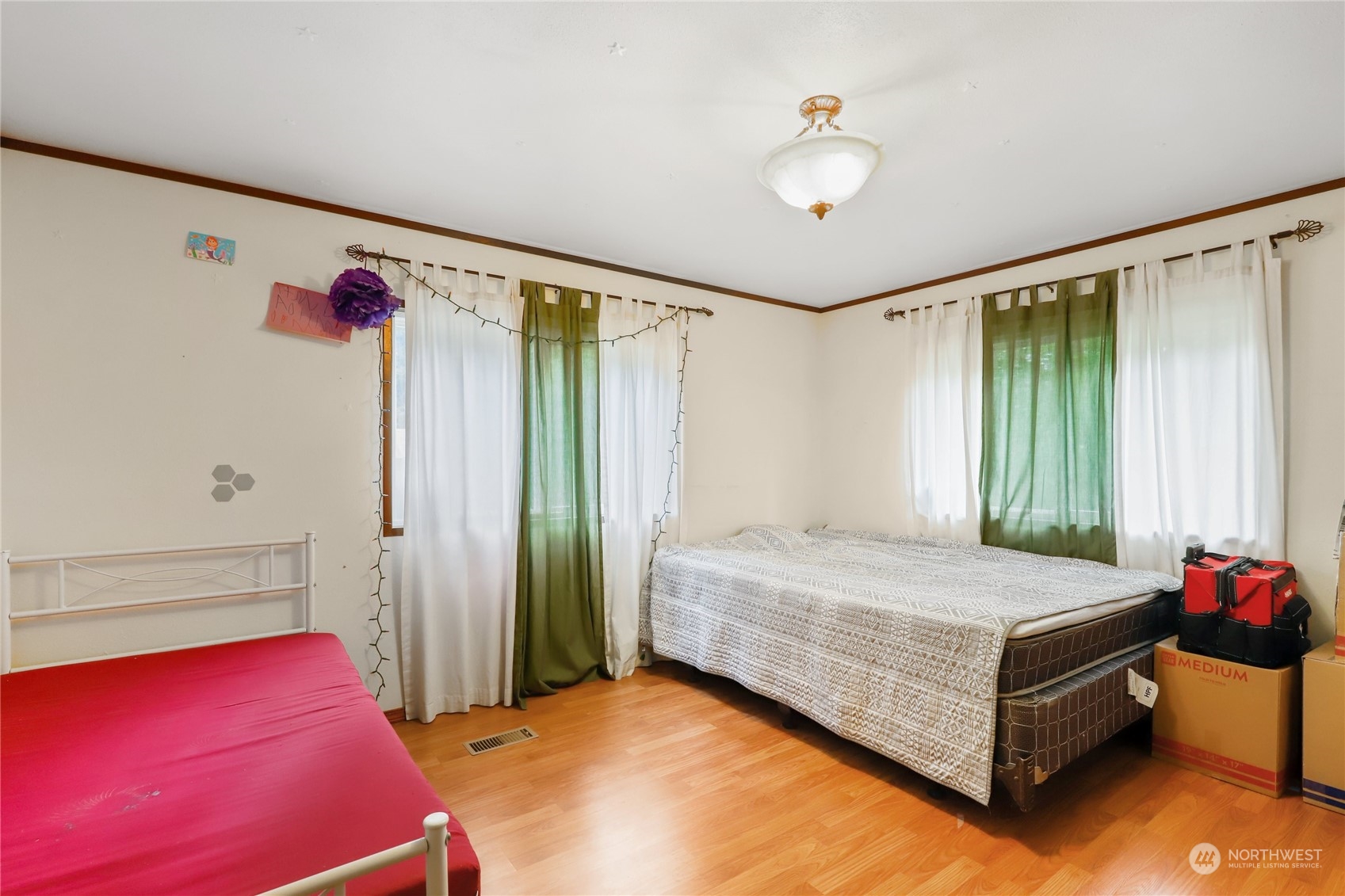 10909 Sidney Road Southwest Port Orchard, WA 98367 - Photo 19 of 34 a bedroom with a bed and a chandelier