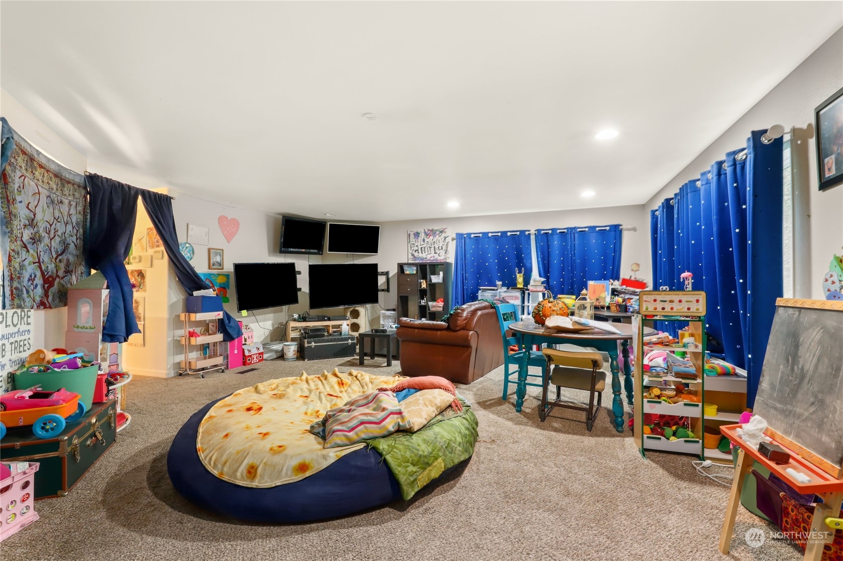 10909 Sidney Road Southwest Port Orchard, WA 98367 - Photo 2 of 34 a living room with lots of furniture and a flat screen tv