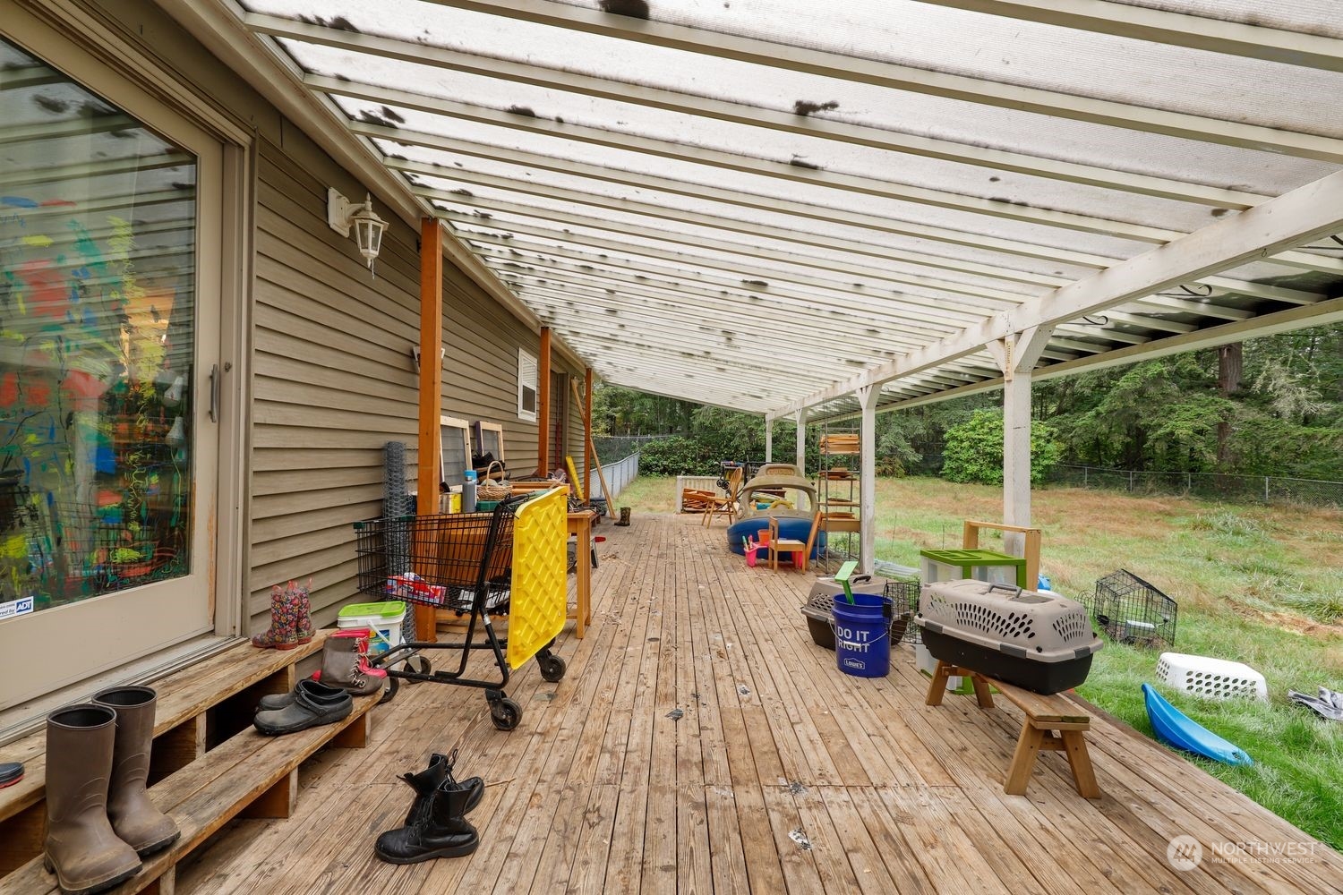 10909 Sidney Road Southwest Port Orchard, WA 98367 - Photo 25 of 34 a view of a patio with couches chairs and wooden floor