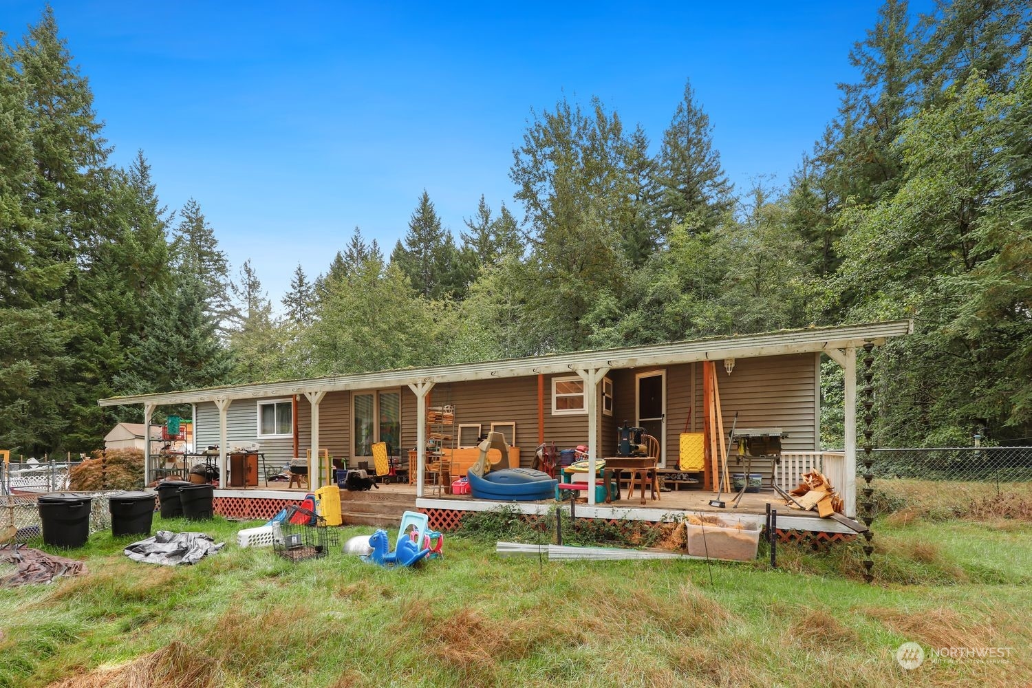 10909 Sidney Road Southwest Port Orchard, WA 98367 - Photo 30 of 34 a front view of a house with garden and sitting area
