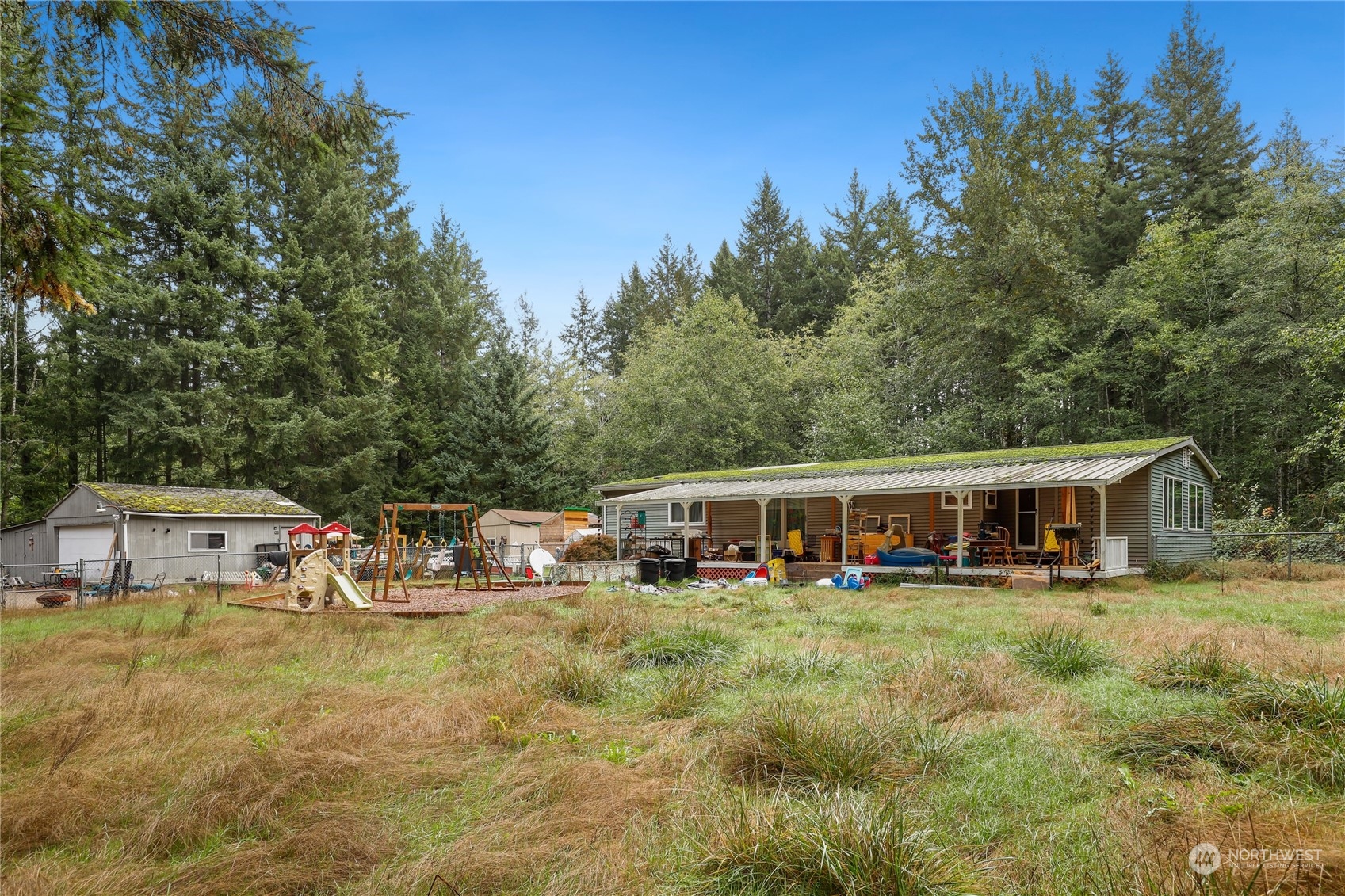 10909 Sidney Road Southwest Port Orchard, WA 98367 - Photo 32 of 34 aerial view of a house with swimming pool and sitting area