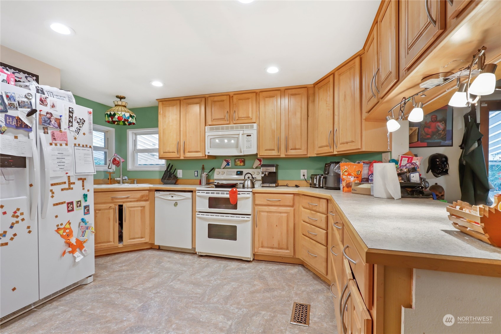 10909 Sidney Road Southwest Port Orchard, WA 98367 - Photo 9 of 34 a kitchen with stainless steel appliances and white cabinets