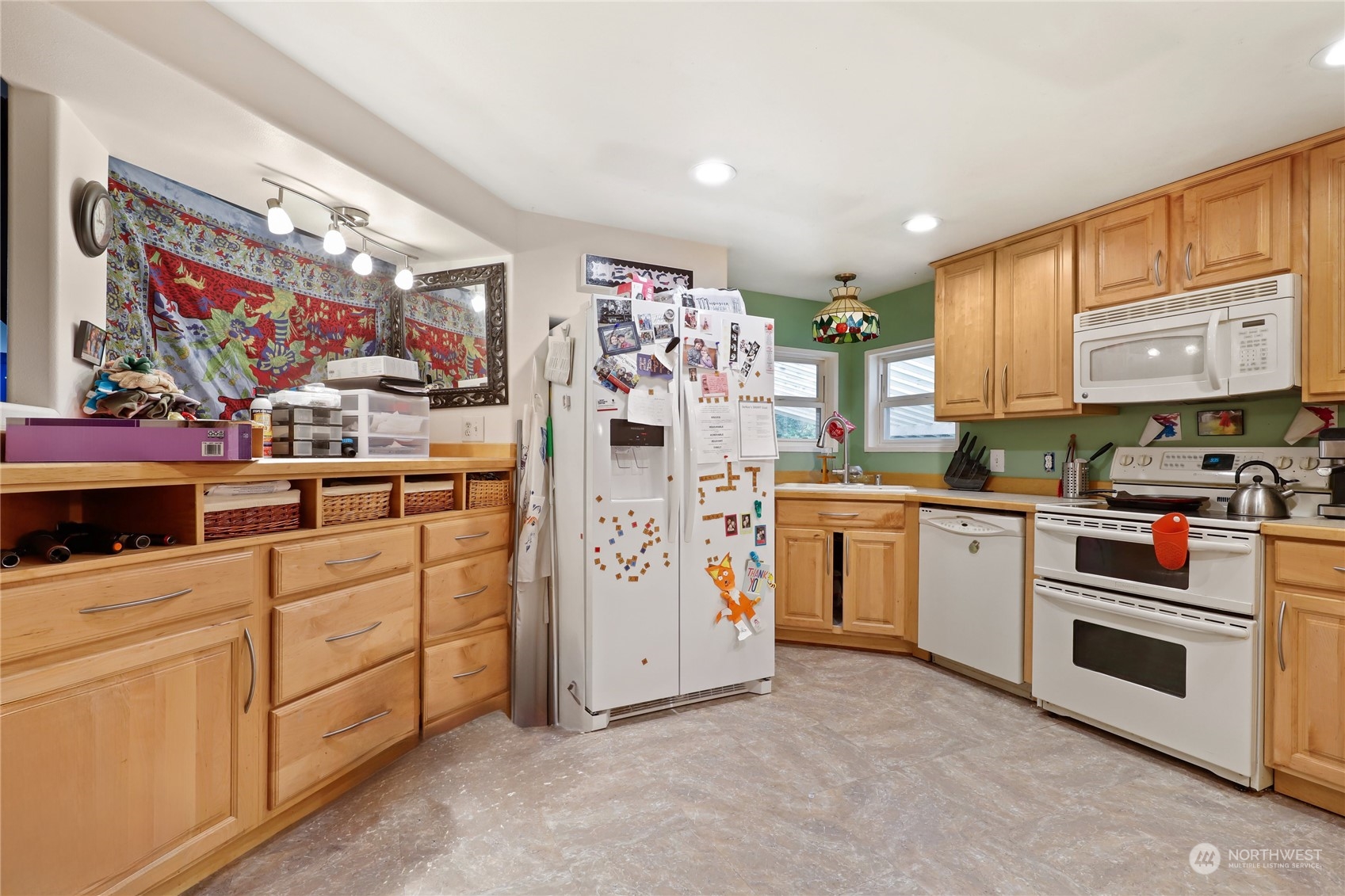 10909 Sidney Road Southwest Port Orchard, WA 98367 - Photo 10 of 34 a kitchen with white cabinets and white appliances