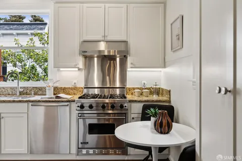 a kitchen with a stove and a refrigerator