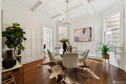 a view of a dining room with furniture wooden floor and chandelier