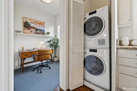 a view of a hallway with washer and dryer