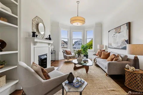 a living room with furniture fireplace and window