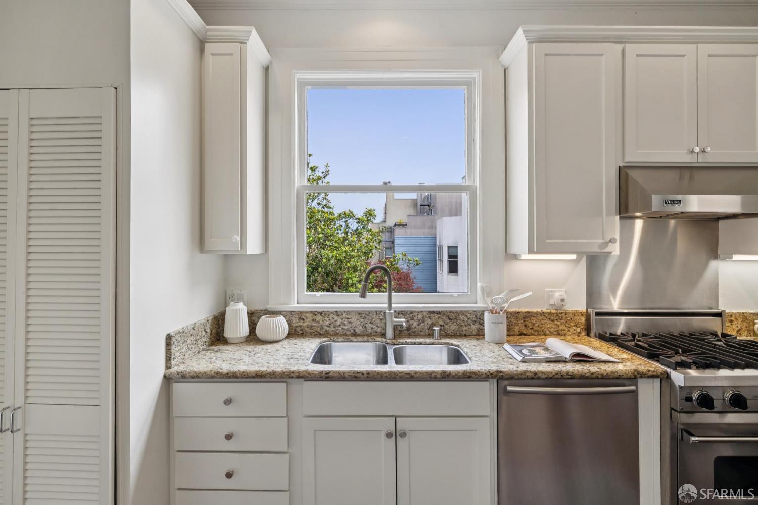 440 Laurel Street San Francisco, CA 94118 - Photo 9 of 24 a kitchen with stainless steel appliances granite countertop a sink stove and cabinets