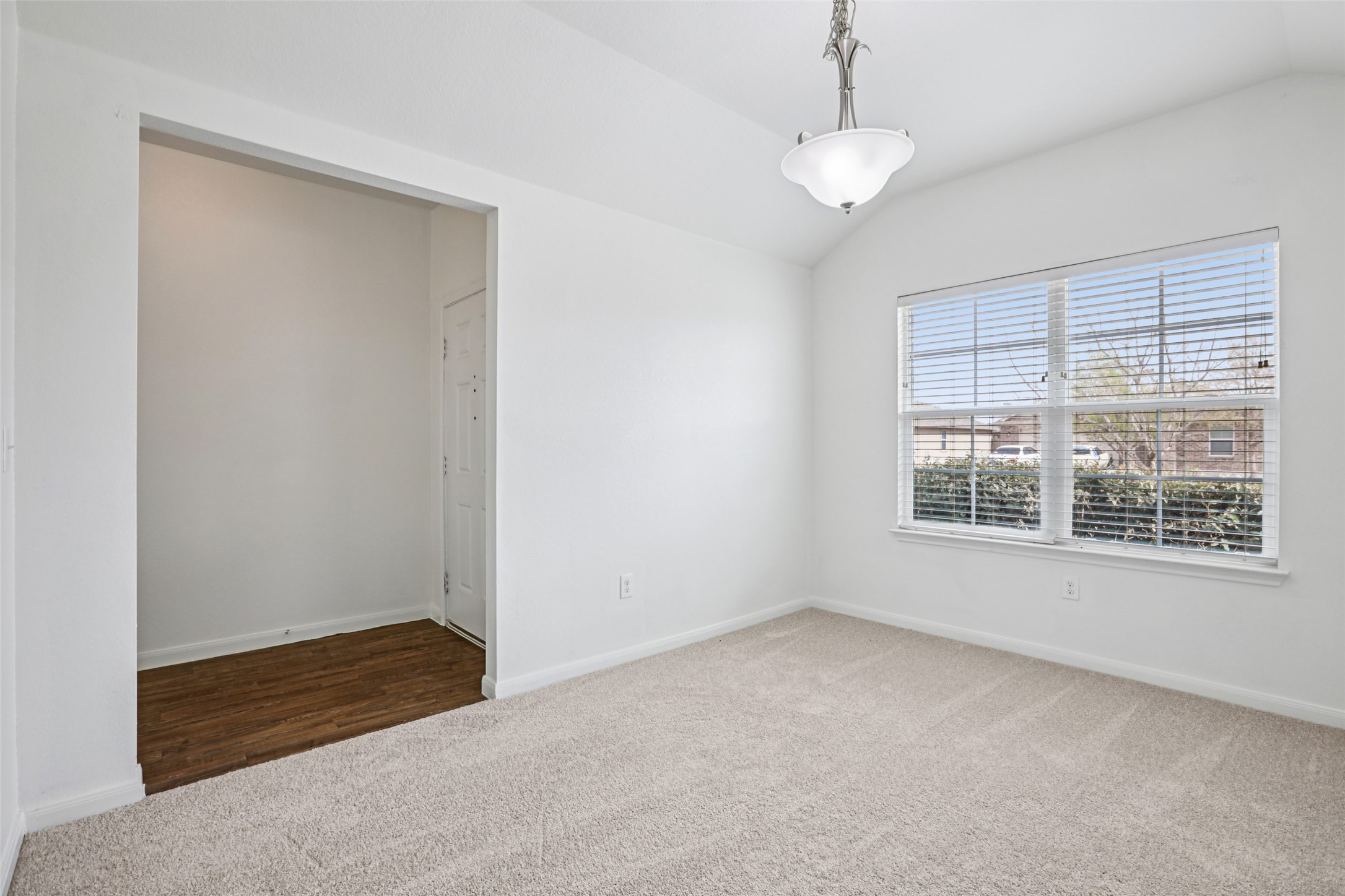 221 Alpha Kyle, TX 78640 - Photo 13 of 37 Carpeted empty room with vaulted ceiling and baseboards
