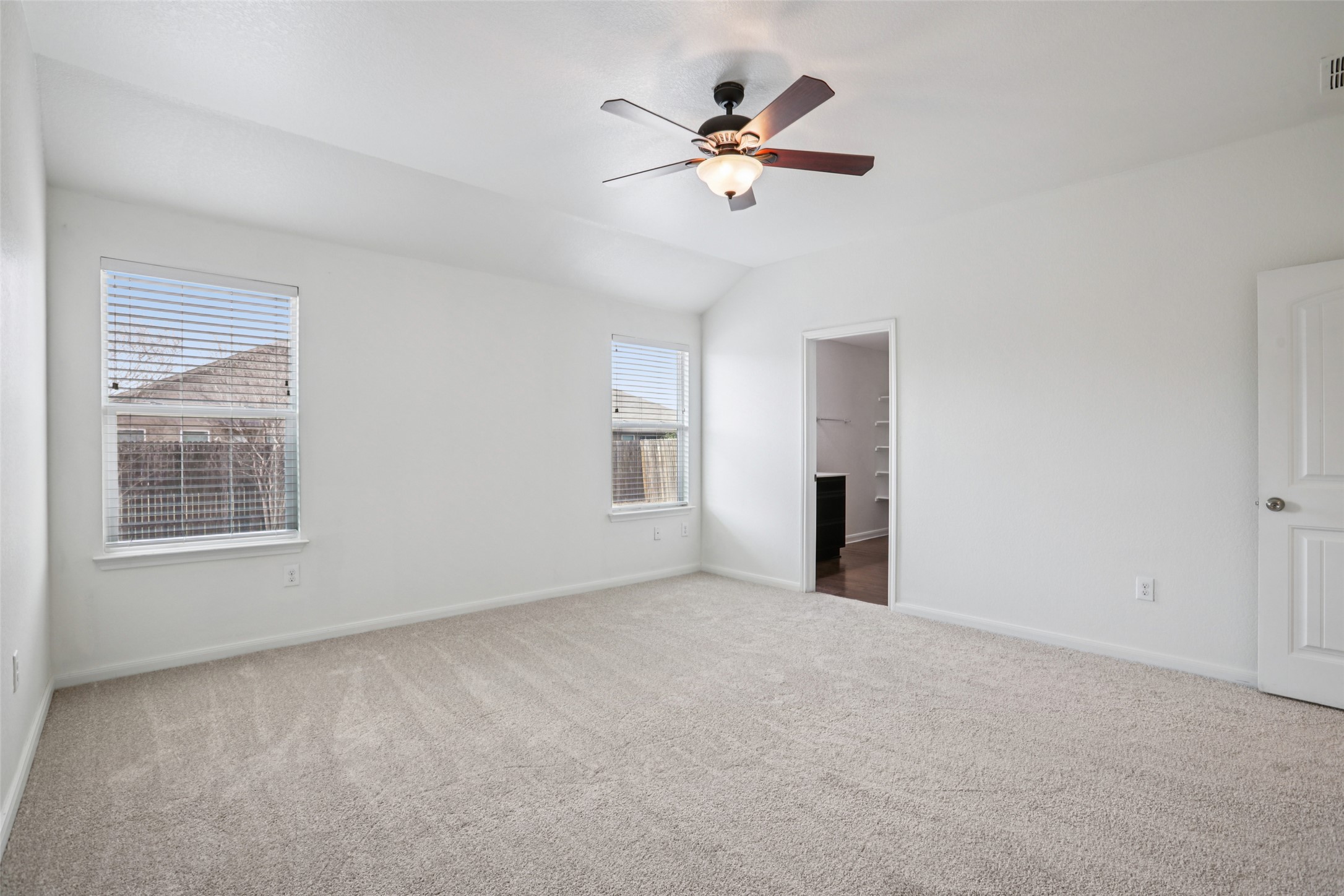221 Alpha Kyle, TX 78640 - Photo 16 of 37 Unfurnished bedroom with carpet floors, ceiling fan, and vaulted ceiling