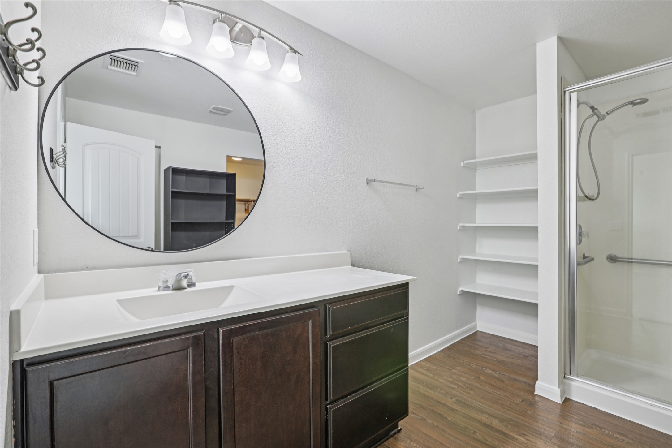 221 Alpha Kyle, TX 78640 - Photo 18 of 37 Bathroom with a shower stall, vanity, and dark wood-style flooring