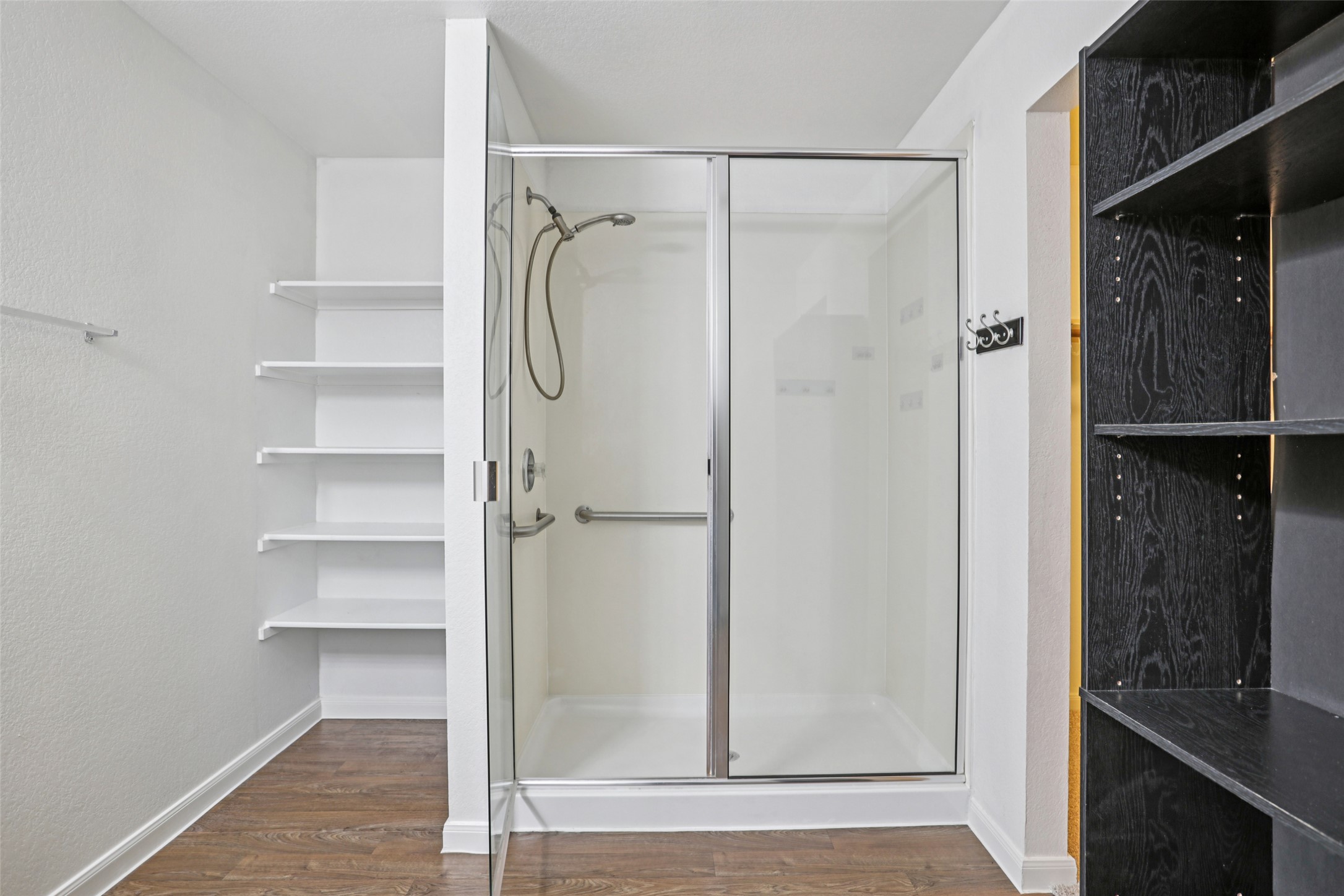 221 Alpha Kyle, TX 78640 - Photo 19 of 37 Bathroom with a shower stall and dark wood-style flooring