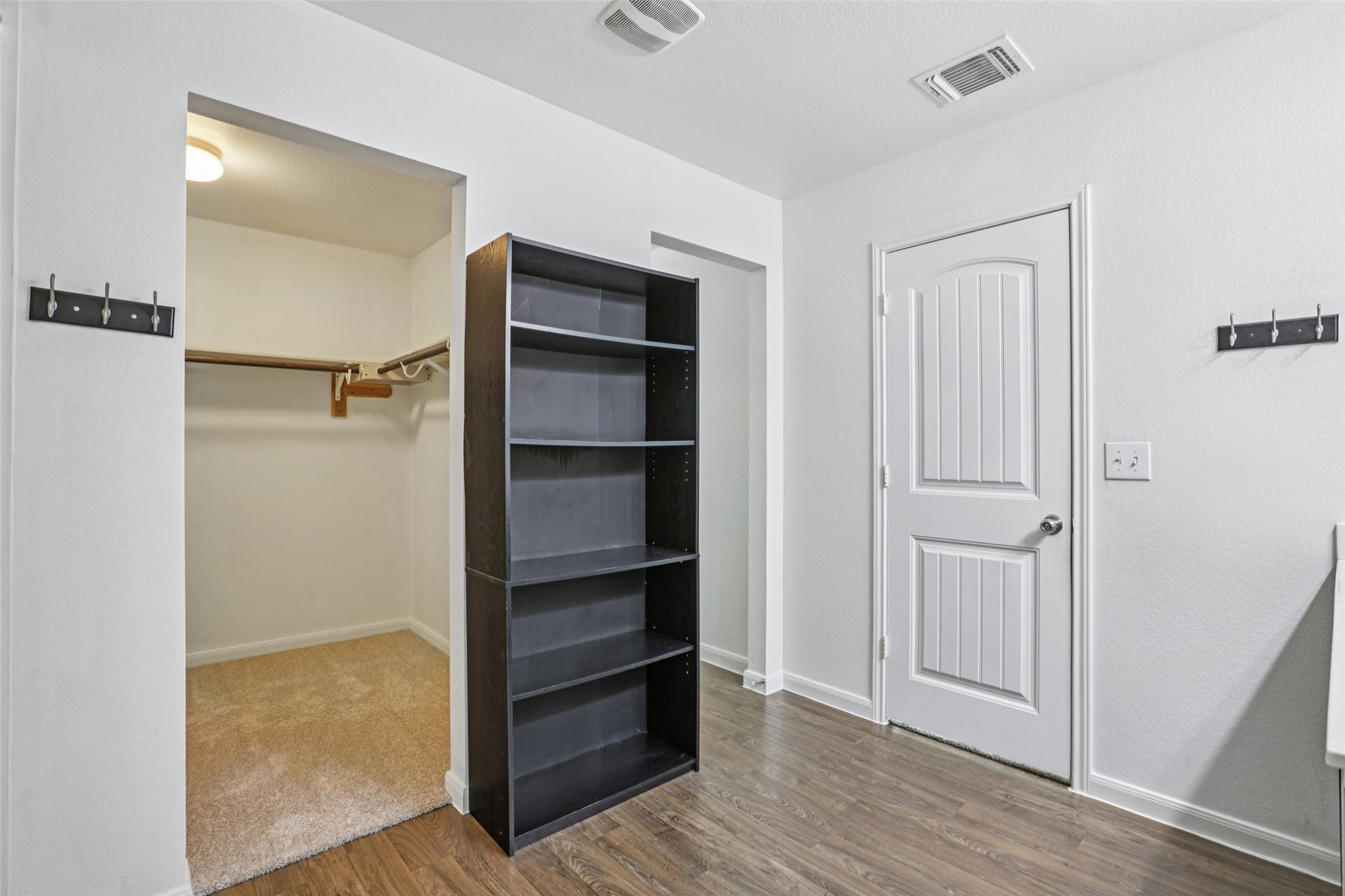 221 Alpha Kyle, TX 78640 - Photo 20 of 37 Unfurnished bedroom with dark wood-style flooring and baseboards