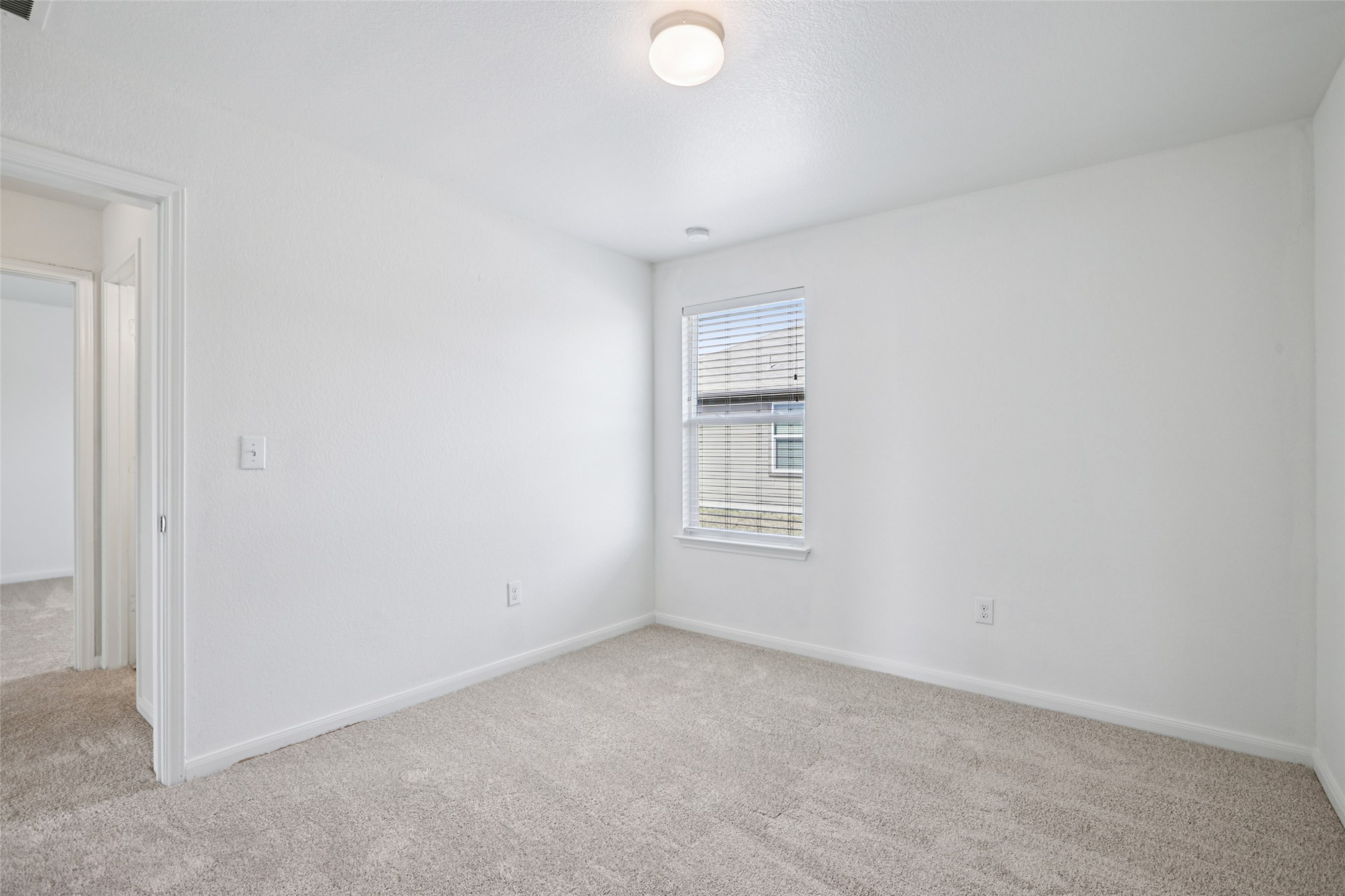221 Alpha Kyle, TX 78640 - Photo 21 of 37 Spare room with light colored carpet and baseboards