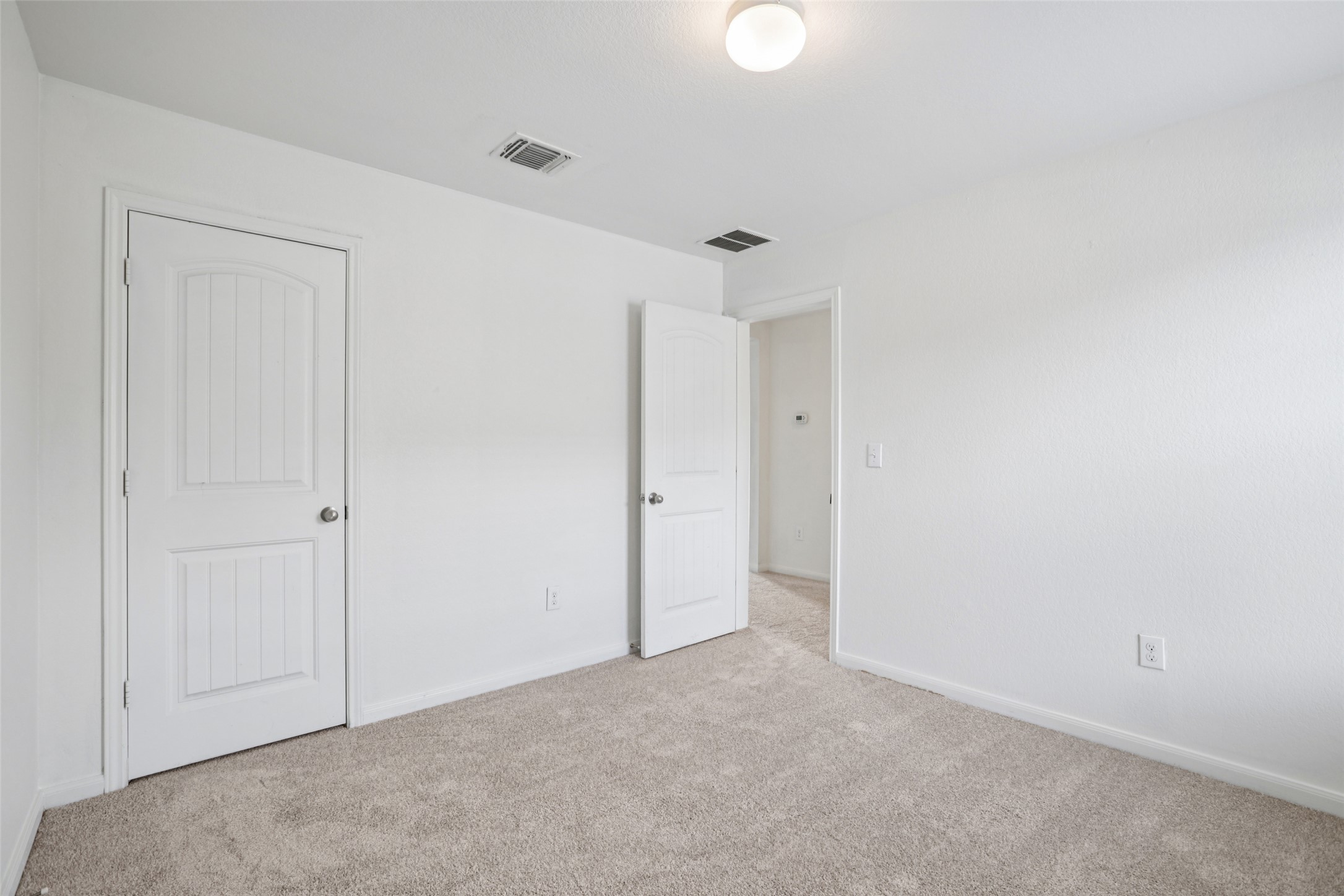221 Alpha Kyle, TX 78640 - Photo 22 of 37 Unfurnished bedroom featuring light colored carpet and baseboards