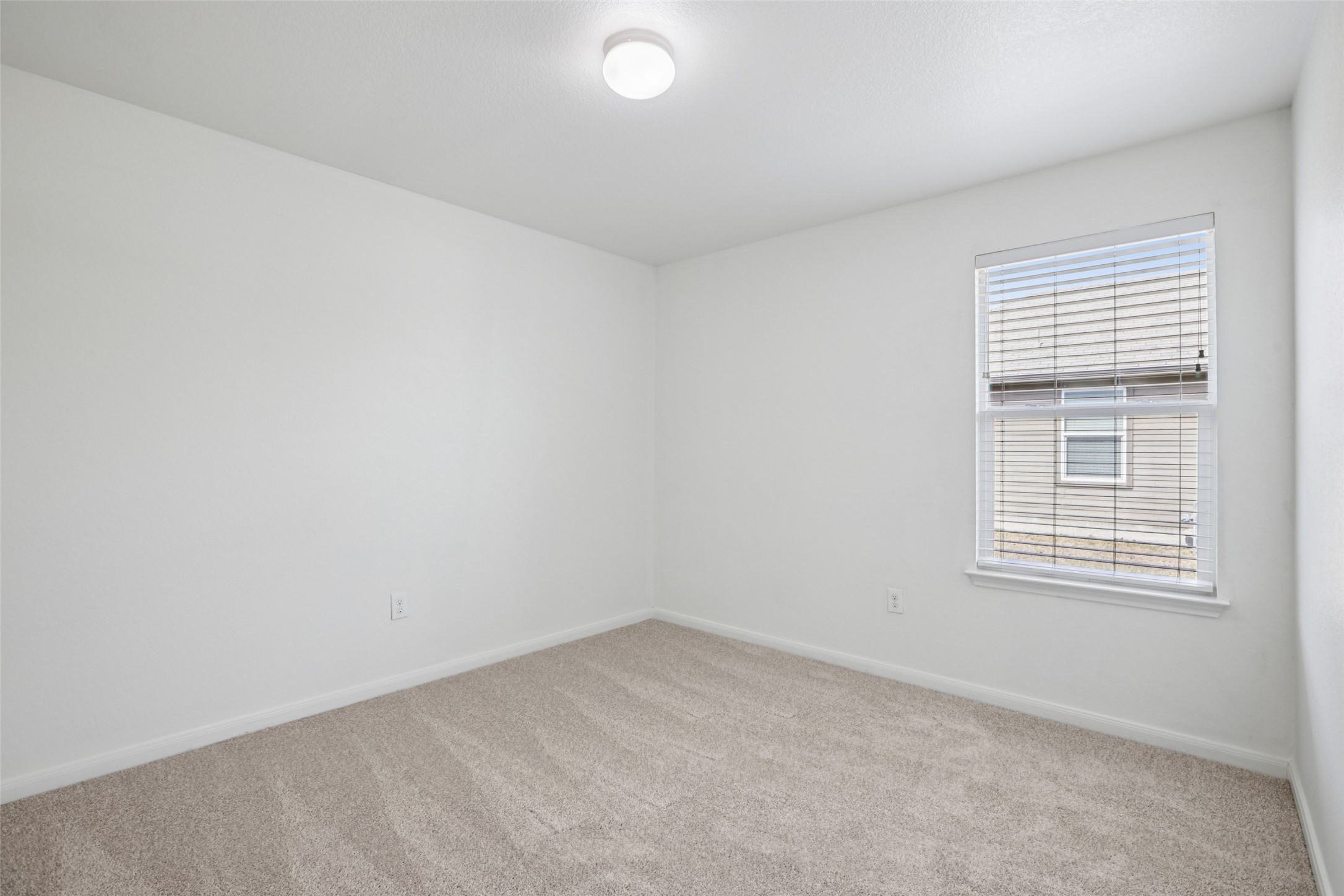 221 Alpha Kyle, TX 78640 - Photo 24 of 37 Spare room with light carpet and baseboards