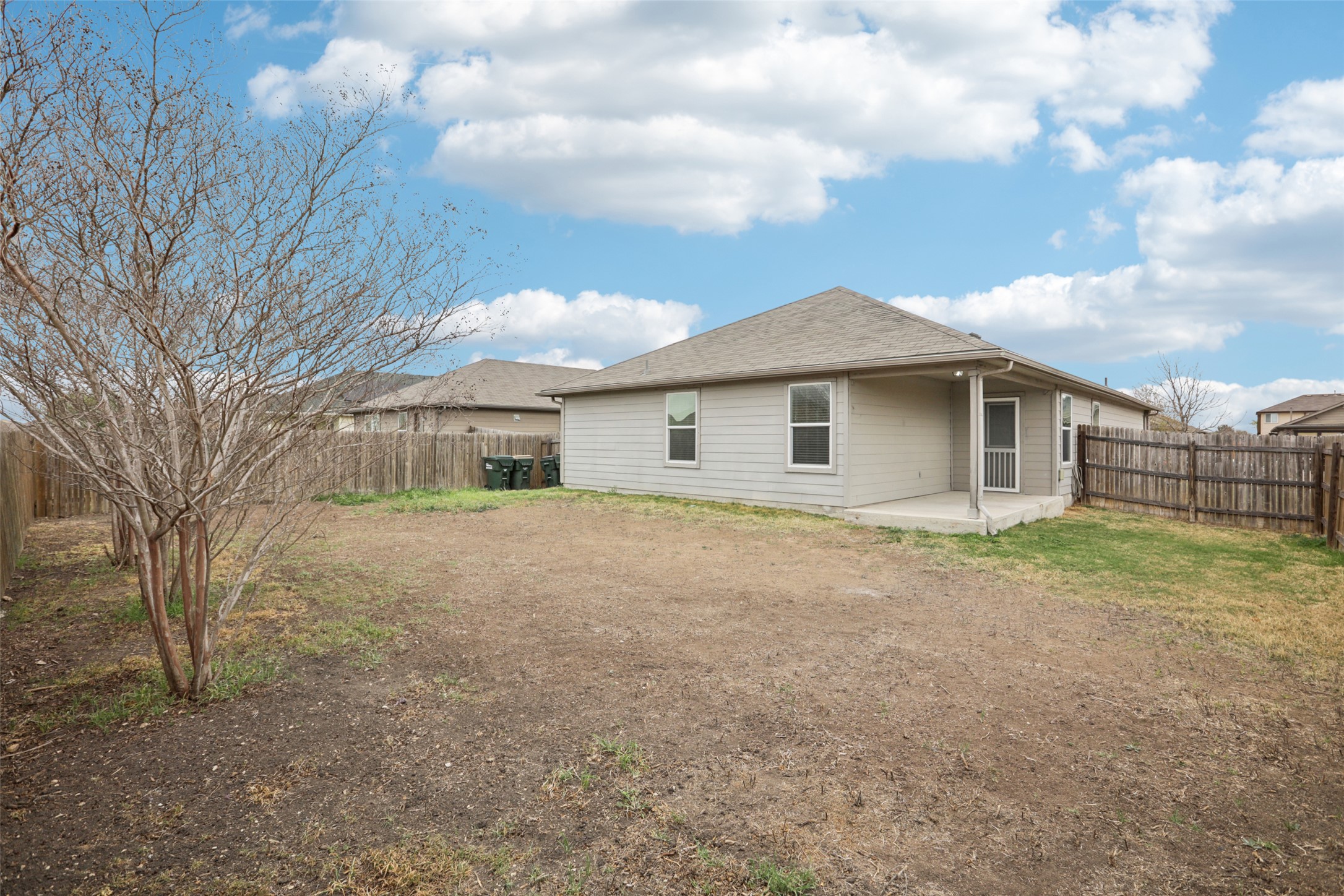 221 Alpha Kyle, TX 78640 - Photo 29 of 37 Rear view of house with a patio and a fenced backyard