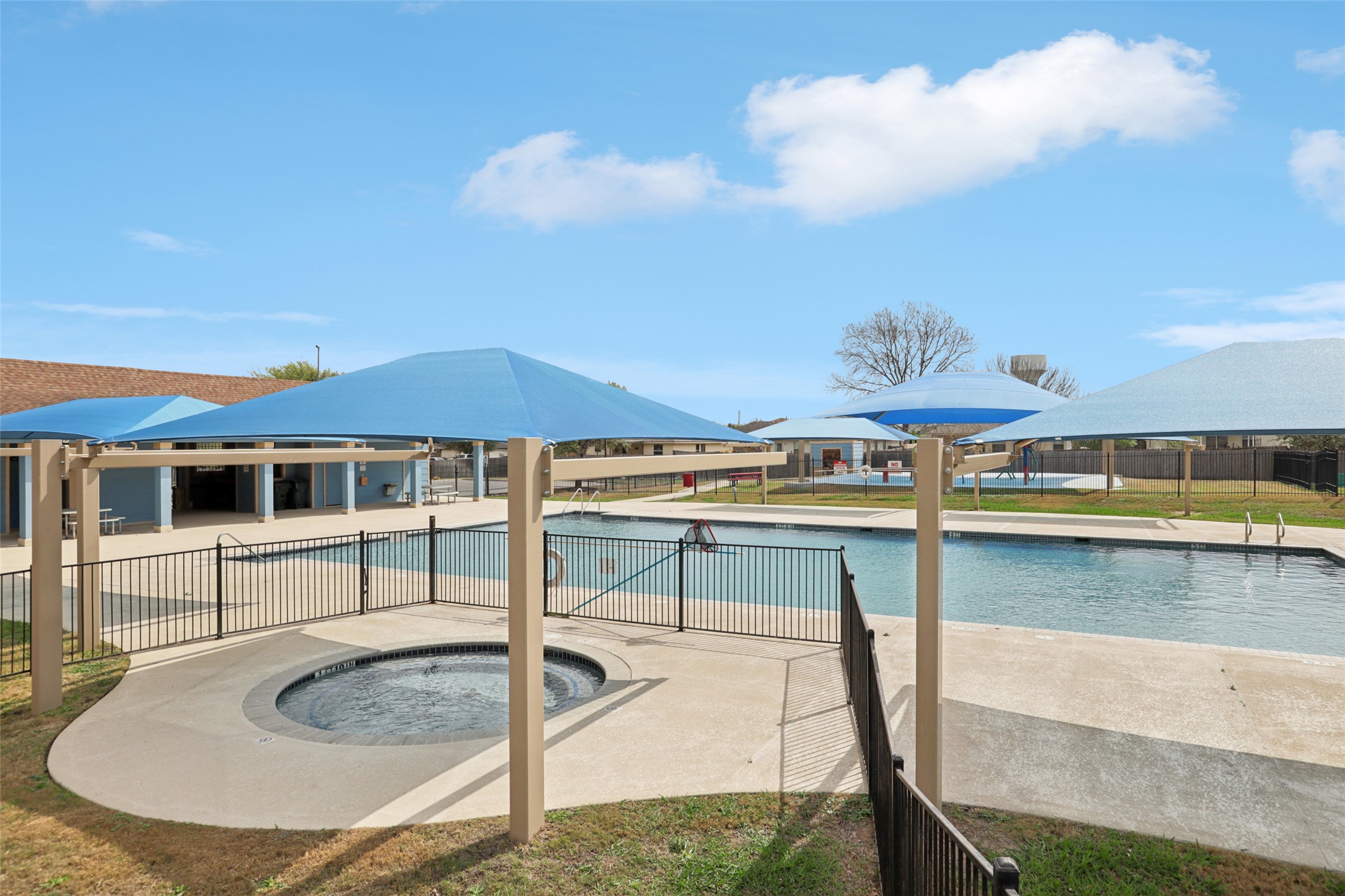 221 Alpha Kyle, TX 78640 - Photo 30 of 37 Community pool with a patio area and a hot tub