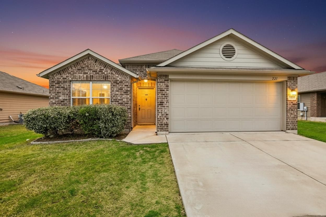 221 Alpha Kyle, TX 78640 - Photo 35 of 37 Single story home with brick siding, a garage, driveway, and a lawn