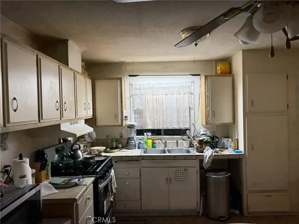 a kitchen with sink refrigerator and stove