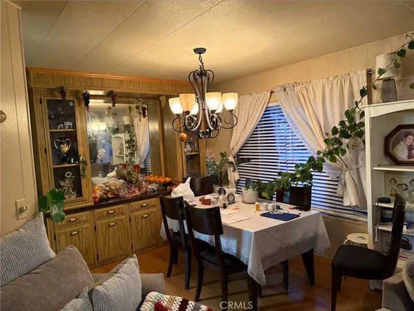 a view of a dining room with furniture and chandelier