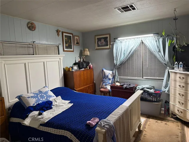 a bedroom with furniture and a bed